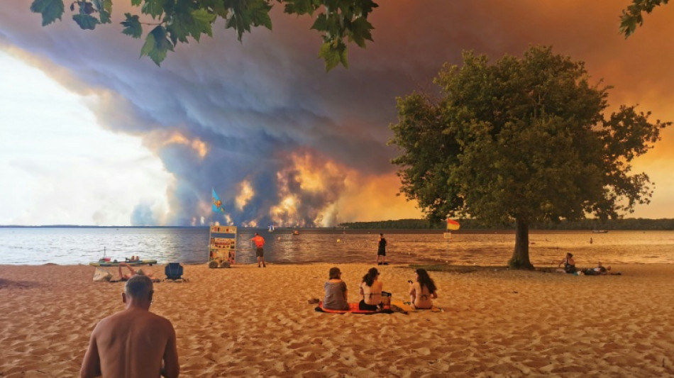  Many thousands flee burning France holiday haven by road and sea 