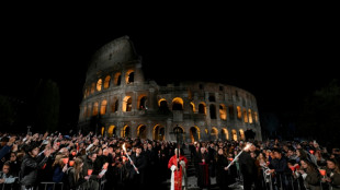 Pope leads torch-lit Colosseum procession before Easter
